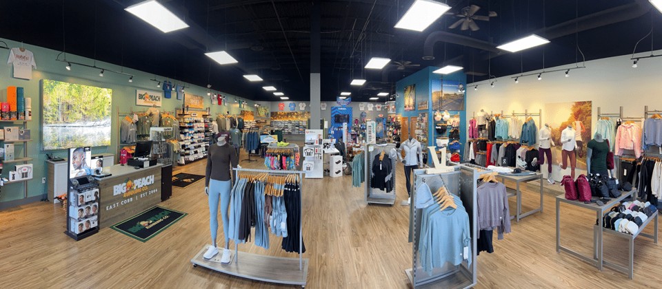 Interior of Big Peach Running Co. East Cobb, showing the fitting area, apparel racks and the front counter